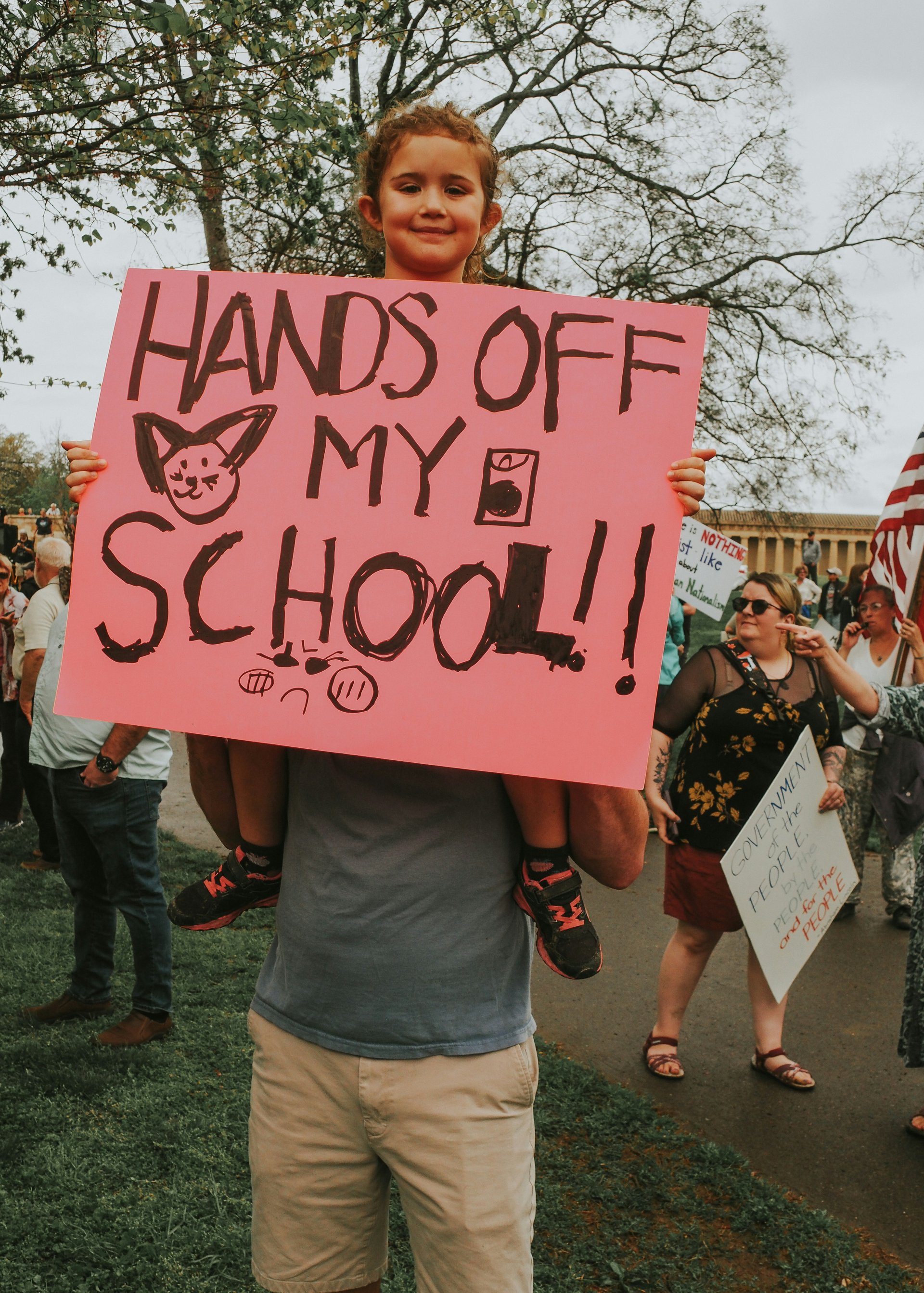 Child holding a sign at a protest in support of school safety