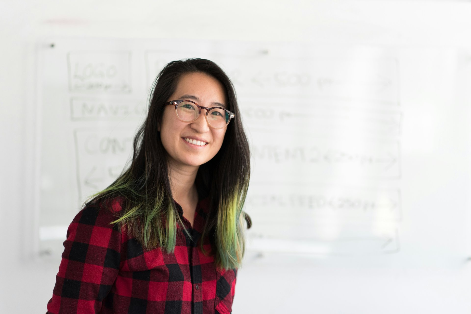 Teacher standing by a whiteboard in a classroom